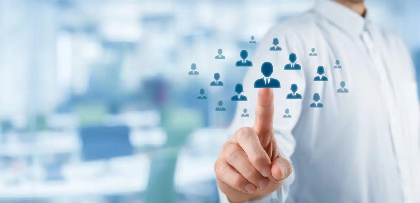 Image of a man pushing a button with people on it.