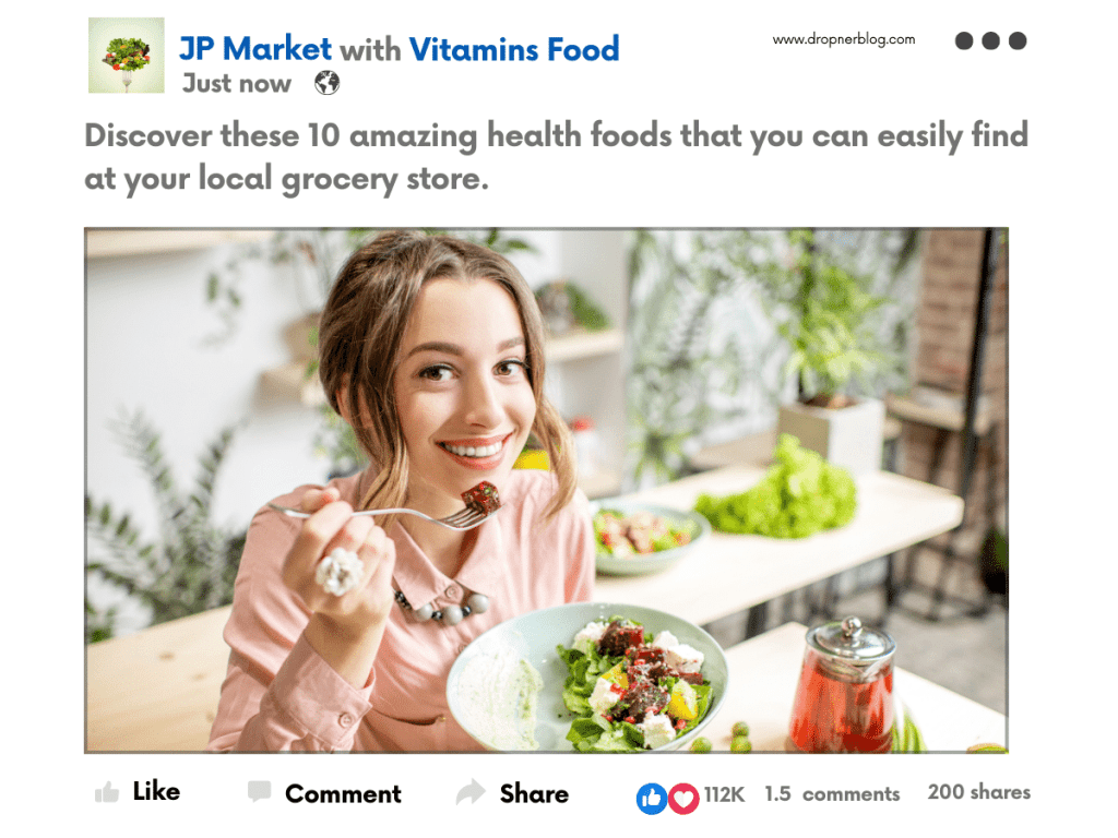 A woman smiling while holding a fork with a salad in front of her, seated at a table with greenery in the background.