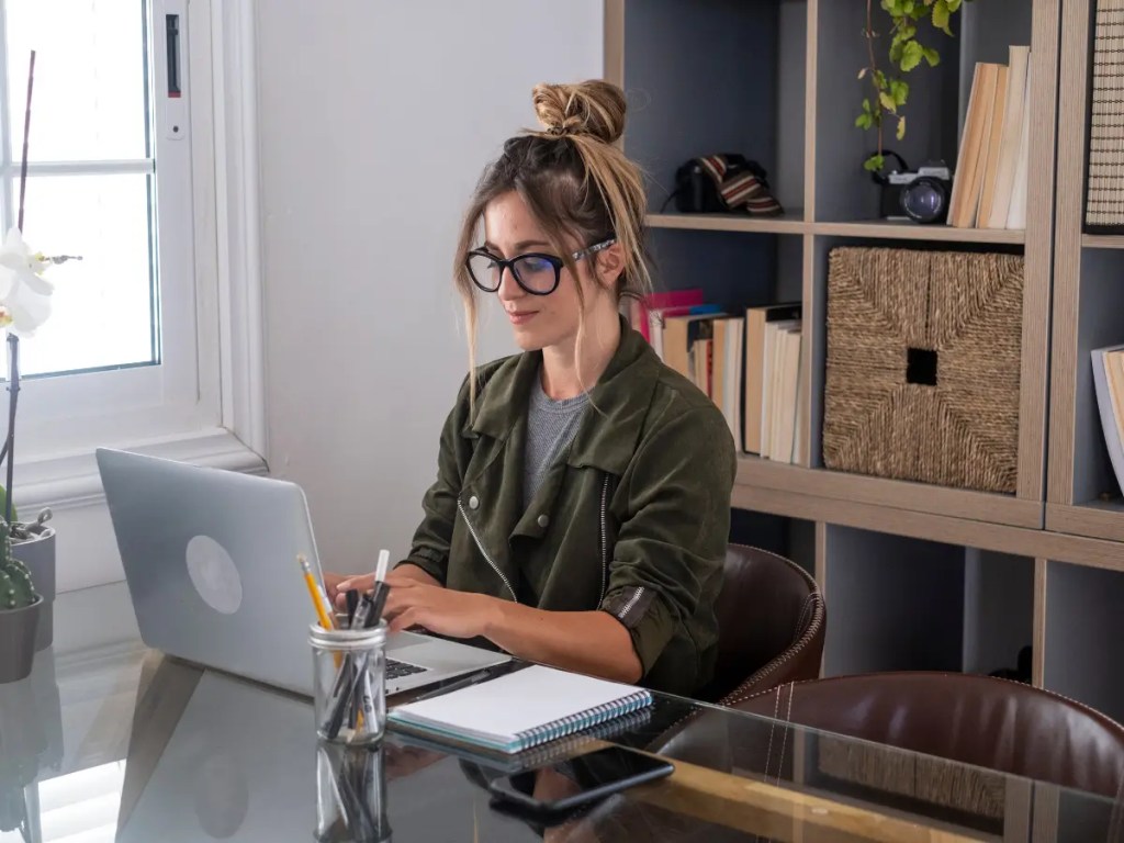 women behind a laptop and desk the title is Grow Your Writing Voice